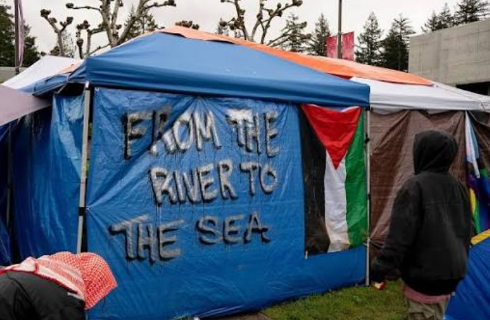 Image of an encampment tent saying from the river to the sea